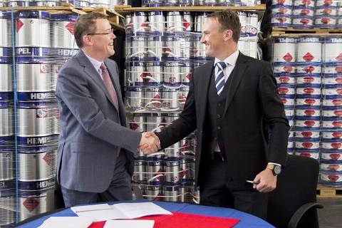 From left to right: Kim Junge Andersen (Group Executive Vice President and CFO) and Johann Geldenhuis (TCMC's General Manager) shaking hands after the deal was signed. (Photo: Hempel)