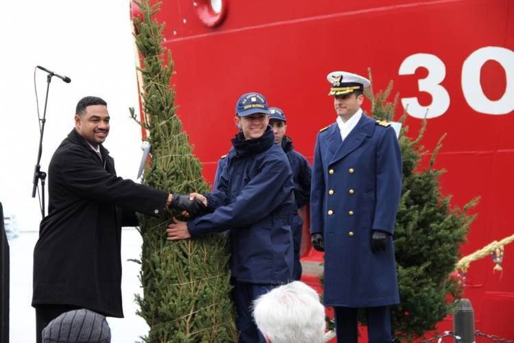 Seaman Jared S. Medina officially delivers the Christmas trees on behalf of U.S. Coast Guard cutter Mackinaw during a ceremony Dec. 3, 2016 at Navy Pier in Chicago. (U.S. Coast Guard photo courtesy of USCGC Mackinaw)