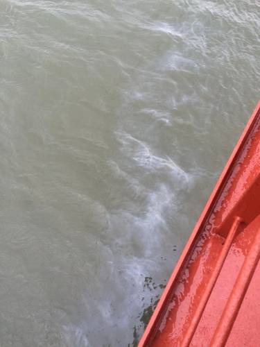 A sheen in the water created by a bulk oil spill from bulk carrier Nord Auckland is, Feb 18, 2016. (U.S. Coast Guard photo by William Russell)