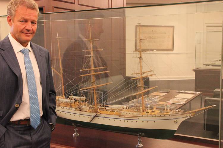 Shipyard boss Dr. Herbert Aly in Front of the German Navy sail training ship Gorch Fock where he was a crew member during his naval service.