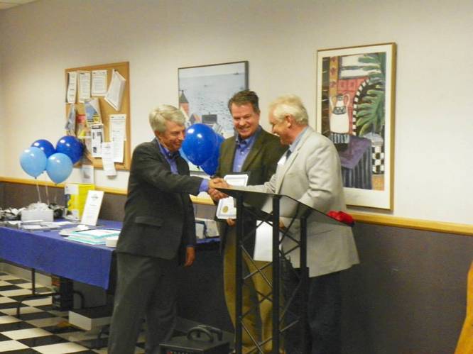 St. Michael, Minnesota Mayor Jerry Zachman presents Jet Edge President Jude Lague and TC/American Monorail President Paul Lague with a resolution from the St. Michael City Council. Photo courtesy I-94 West Chamber of Commerce.