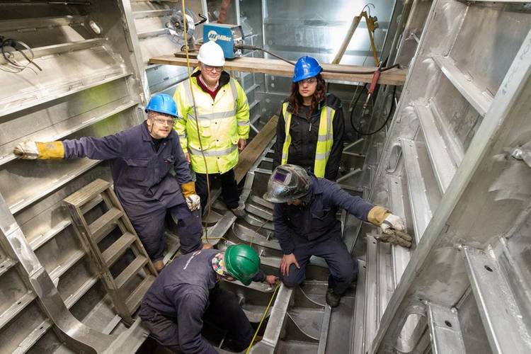 Stewart Graves, managing director, and Rita Beard, safety officer, observing work being carried out by Benjamin Cardew, Paul Hethrington and Richard Davey on the 20m BMT Nigel Gee design wind farm support vessel (Photo courtesy of Mustang Marine)