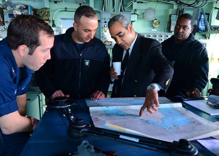 SUEZ CANAL (April 5, 2013) Egyptian pilot Mohamed El-Said shows Sailors a Suez Canal chart aboard the amphibious dock landing ship USS Carter Hall (LSD 50) as they begin a transit of the canal as part of the Kearsarge Amphibious Ready Group with the embarked 26th Marine Expeditionary Unit.  (U.S. Navy photo by Mass Communication Specialist 3rd Class Chelsea Mandello)