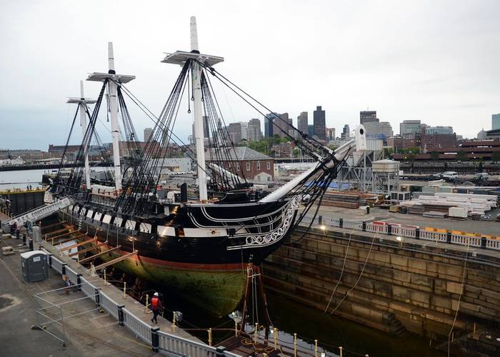 The entire hull of USS Constitution is exposed for the first time in 19 years as Dry Dock 1 in Charlestown Navy Yard is dewatered. Constitution entered the dock last night to commence a multi-year planned restoration period.