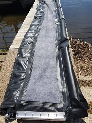The inland mitigation system prototype that shows the incorporation of the X-Tex fabric into the barrier design.  This is meant to deflect oil towards the shoreline for easier recovery.