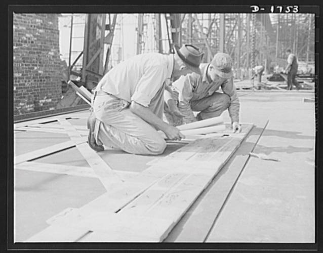  These workers at Newport News are marking off the design for a ship’s plate, using a template as a guide – 1941. (Credit – Library of Congress)