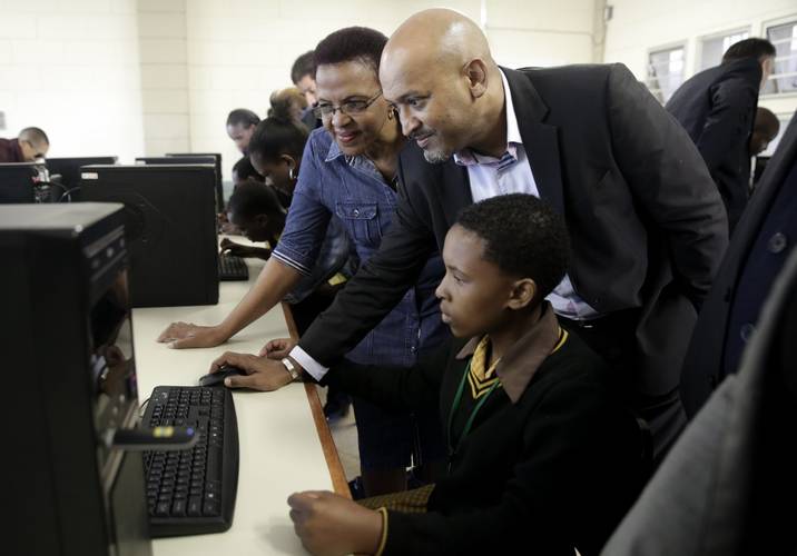TNPA Chief Executive Richard Vallihu pictured with a learner and educator at Soweto-on-Sea Primary School. The school received 10 computers donated by Cavotec as part of the contractor’s corporate social investment contribution under the mooring system contract (Photo: TNPA)
