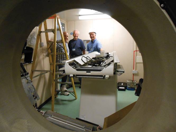 Tom Velnosky, Bio-Med Engineer, Roger Nowicki, Project Manager and Ken Berry, Director of Marine Operations of Mercy Ships, preparing to remove the old CT Scanner. 