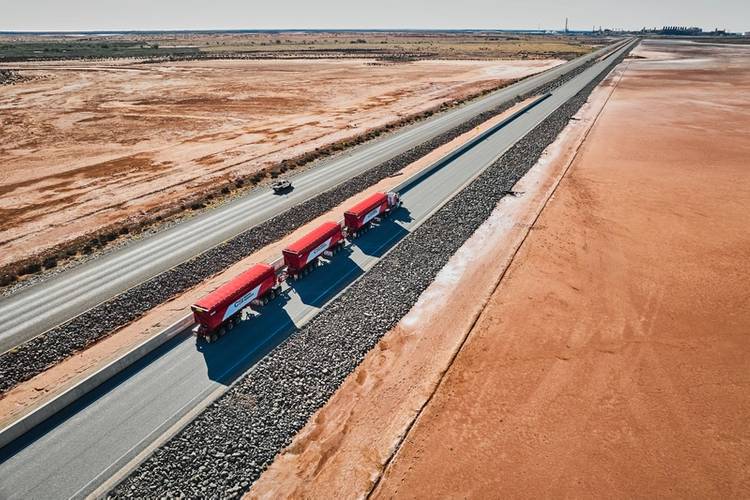 The ore is transported by jumbo road trains which make the 150-kilometer journey from Ken’s Bore mine site to the Port of Ashburton on a dedicated and private haul road. Image courtesy of MinRes.