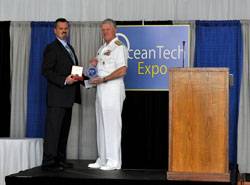 U.S. Navy CNO Admiral Gary Roughead (right) receiving the Seamaster 2011 award from Greg Trauthwein, Associate Publisher and Editor, Marine Technology Reporter, at the OceanTech Expo 2011 in Newport, RI. (Photo: U.S. Navy)