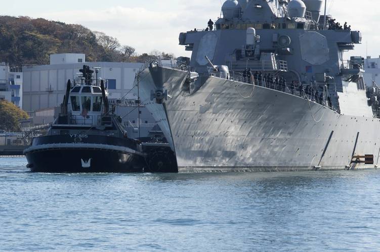 USS John S. McCain is towed to a pier at Fleet Activities (FLEACT) Yokosuka. (U. S. Navy photo by William McCann)