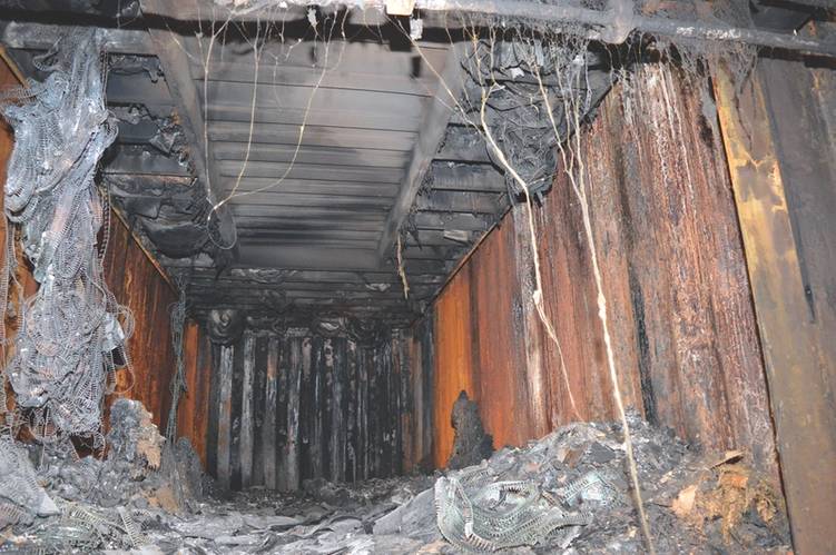 A void within a stow of containers in a hold as the result of structural failure of a unit lower in the stack.