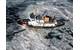 The Coast Guard Cutter Thunder Bay breaks ice in the Straits of Mackinac between Lake Huron and Lake Michigan. (U.S. Coast Guard photo)