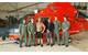 A Coast Guard Air Station Corpus Christi MH-65 Dolphin helicopter aircrew stands with two rescued divers after they were located and rescued Saturday, June 27. (U.S. Coast Guard photo)