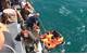 Coast Guardsmen from U.S. Coast Guard Cutter Maui rescue five Iranian mariners after they were found adrift in a life raft. U.S. Navy video capture.