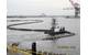 Dredged sand was used to cap or close the Newark Bay CDF. This photo shows the floating pipeline that connected the dredge to the pump barge at the CDF site. Credit: Linda Guenther, Project Engineer, Dredging Program, New York District, U.S. Army Corps of Engineers.