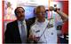 Rear Adm. Matthew Klunder, chief of naval research, tries out a low cost augmented reality head mounted display with SA Photonics general manager, Michael Browne, while touring the exhibit hall at the 2014 Navy Opportunity Forum. The forum is designed to facilitate interaction between small business and members of the acquisition community, lead system integrators, and first and second tier suppliers. (U.S. Navy photo by John F. Williams)