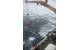Members of the Coast Guard Cutter Healy deck department lower an oil skimmer into the ice-laden Beaufort Sea. Multiple Coast Guard units and partner agencies and organizations, coordinated by the Coast Guard Research and Development Center, cooperated to accomplish the exercise, which explored the potential for present technology to respond to an oil spill in the extreme Arctic environment. (U.S. Coast Guard photo by Petty Officer 3rd Class Grant DeVuyst)
