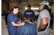 Petty Officer 1st Class Jennifer Gonzales, a yeoman assigned to the Coast Guard 13th District Auxiliary division, speaks with Seattle Seahawks players Terrance Parks (right) and Rashaun Allen (USCG photo by Katelyn Shearer)