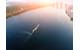 Russia's invasion of Ukraine emphasizes the importance of efficient maritime traffic to national security and the world economy. Pictured is an aerial cityscape of Kiev and river Dnipro at sunset, with a tugboat and barge heading down river Dnieper. Copyright Kirill Gorlov/AdobeStock